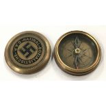 A brass cased compass bearing German Swastika detail.