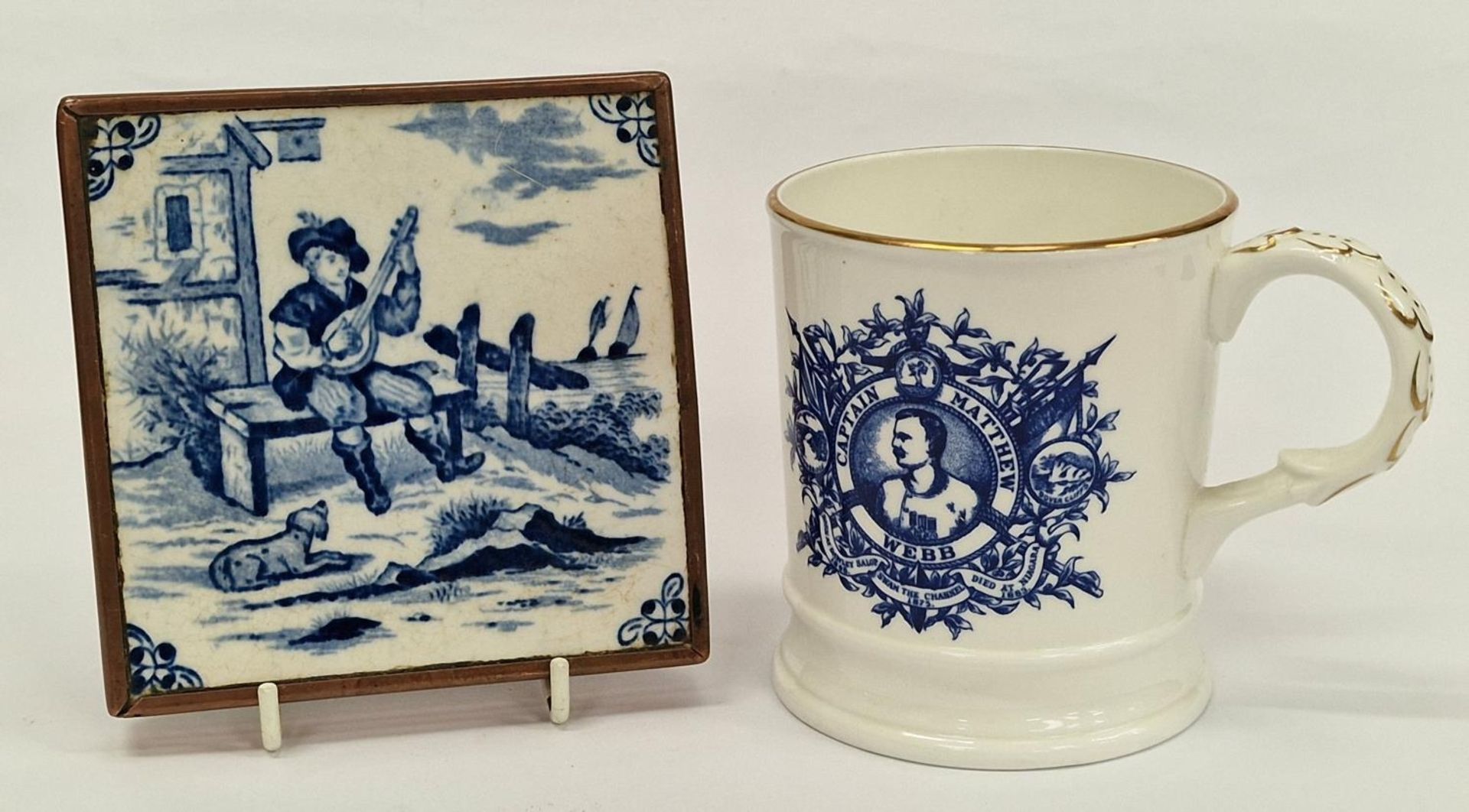 Delft blue brass edge tile together a commemorative cup.