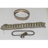 Three antique silver and metal bracelets/bangles.