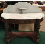 A Victorian mahogany marble topped washstand with splash back on turned supports and drawer to