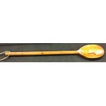 Very very large wooden spoon with wording down the handle saying ‘king size spoon for a king size