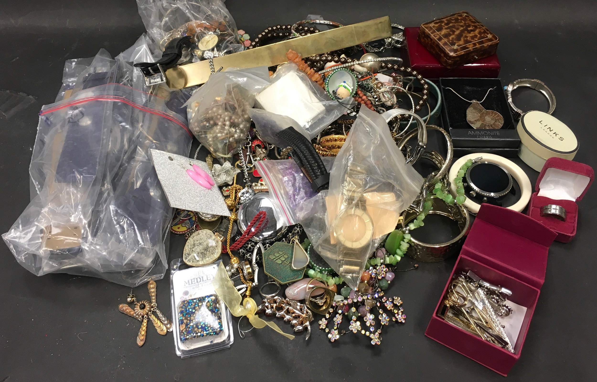 Plastic tub containing a large collection of costume jewellery.