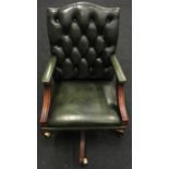 Chesterfield style button back adjustable revolving office arm chair on wooden base and castors