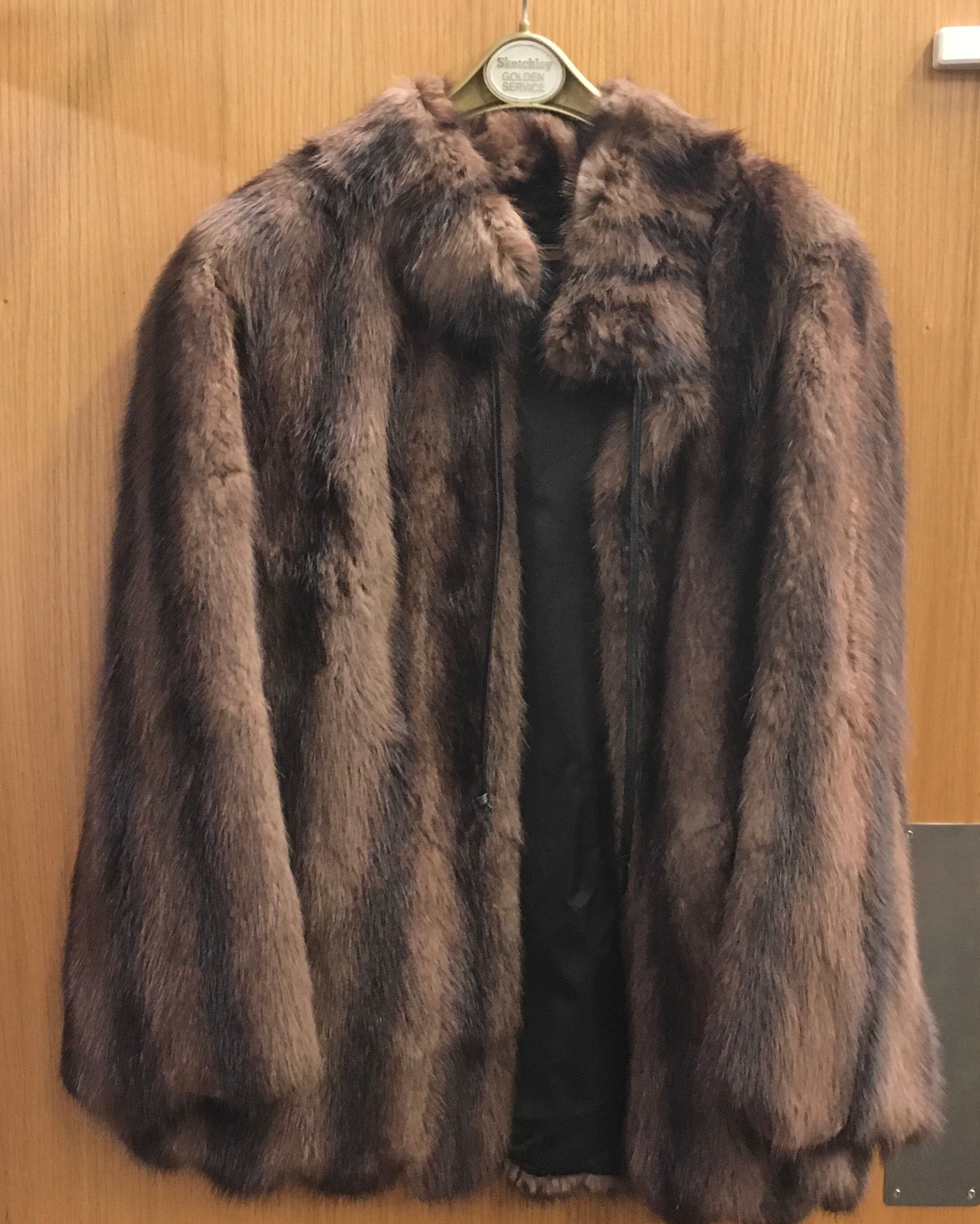 Two vintage short fur coats, one dark brown one cream