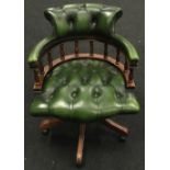 Chesterfield style button back revolving secretaries office chair on wooden supports with castors