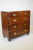 A C19th mahogany chest with brass mounts and military inset handles, raised on turned supports,