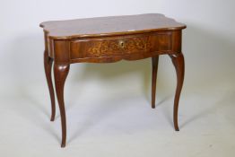 A C19th Dutch marquetry inlaid walnut single drawer side table, with shaped top and sides, raised on