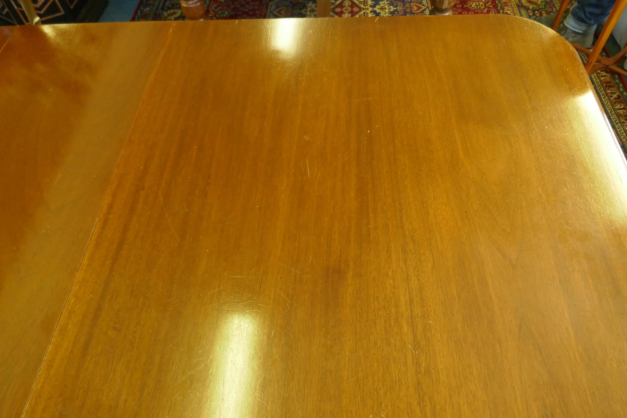 A Regency style mahogany four pedestal dining table with three extra leaves, the solid top with - Image 5 of 9
