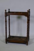 A Victorian oak stick stand with bobbin turned supports and metal tray, 19" x 11" x 28"