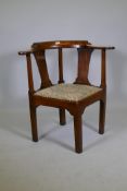A Georgian elm corner chair, with bow back and shaped back splat and drop in seat raised on square