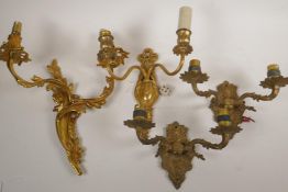 A pair of brass two light wall sconces and two ormolu two light sconces, largest 14"