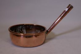 An antique copper pan, 12" diameter