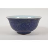 A Chinese blue glazed porcelain rice bowl with underglaze lotus flower decoration, 6 character