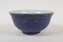 A Chinese blue glazed porcelain rice bowl with underglaze lotus flower decoration, 6 character