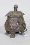 A Chinese bronze vessel with archaic style raised decoration with bird shaped cover, raised on