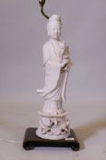 A Chinese blanc de chine figure of Quan Yin, mounted on a wood base as a lamp, AF cracks to base,