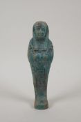 An Egyptian turquoise glazed faience shabti, 6½" high