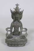 A bronze four faced Buddha figure, with verdigris patination, 9" high