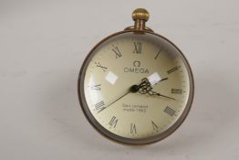 A glass and brass desk top ball clock paperweight, 2" diameter