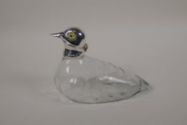 A silver plated and glass duck decanter, with inset glass eyes, 7" long