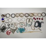 A quantity of vintage costume jewellery, mostly bangles and necklaces, including a sterling silver
