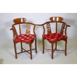 A pair of Chinese hardwood corner chairs, with carved and pierced back splats, late C20th