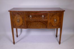 A Georgian III mahogany bowfront sideboard with two drawers flanked by two cupboards, raised on