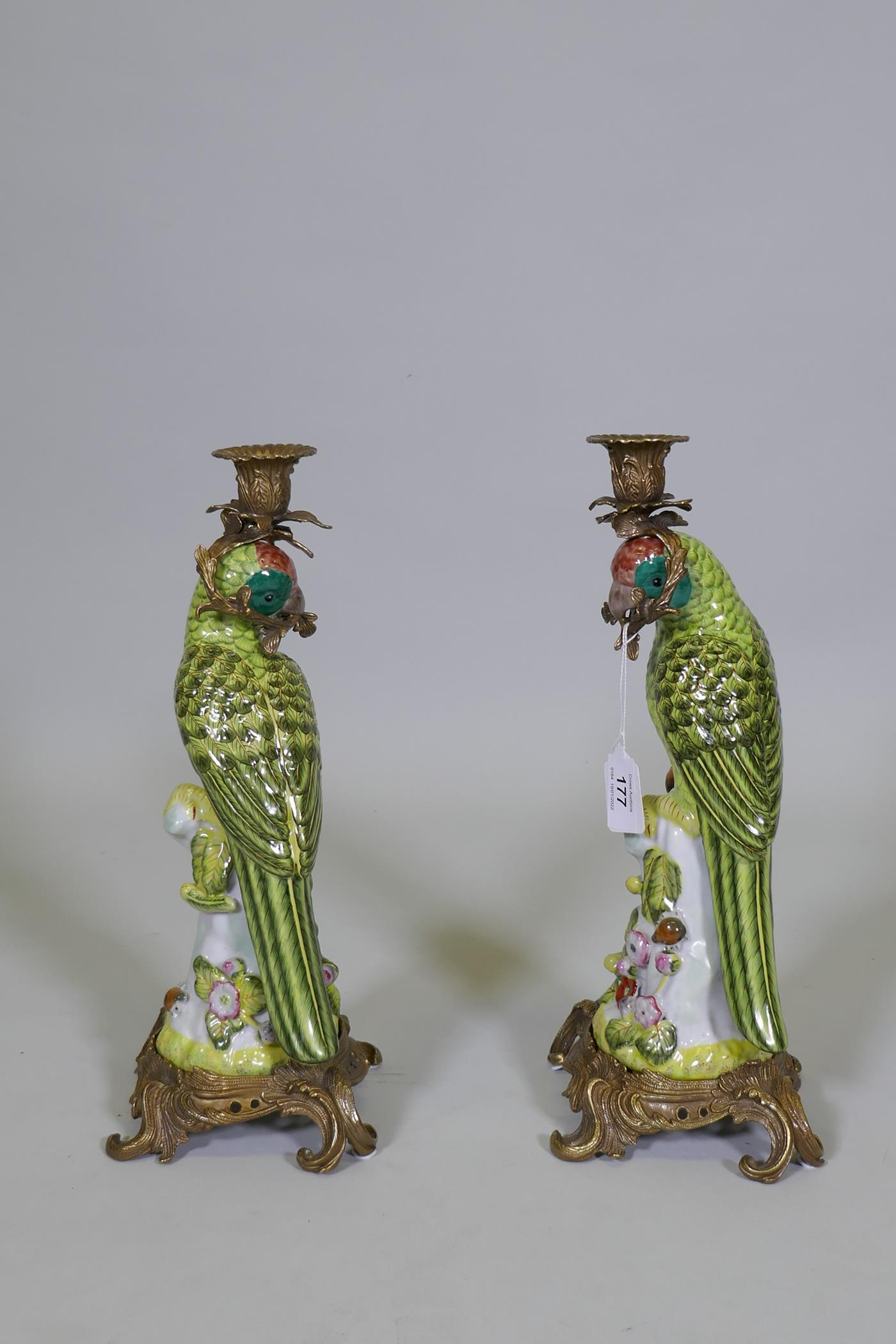 A pair of porcelain parrot candlesticks with brass mounts, decorated in bright enamels, marked to - Image 5 of 8