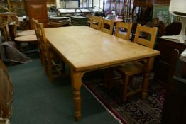 A pine farmhouse kitchen table and eight ladderback chairs en suite, 96" x 47"