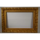 A C19th gilt composition picture frame, with leaf and fruit decoration, rebate 16" x 26"