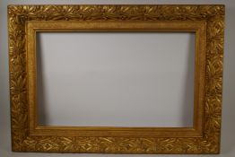 A C19th gilt composition picture frame, with leaf and fruit decoration, rebate 16" x 26"