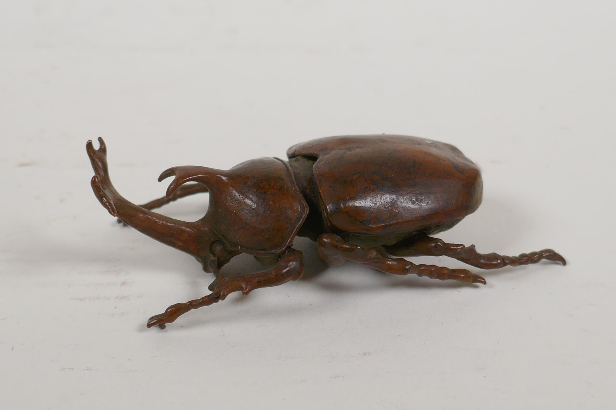 A Japanese Jizai style okimono in the form of a rhinoceros beetle, the carapace opening to reveal an - Image 3 of 5