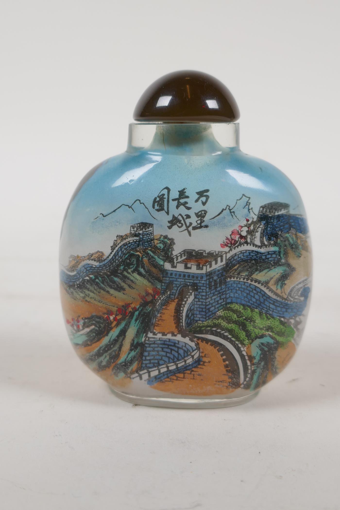 A Chinese reverse decorated glass snuff bottle depicting the great wall and a portrait of a noble, - Image 2 of 5