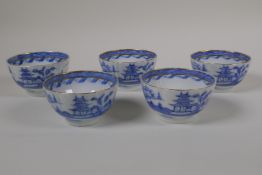 Five blue and white porcelain tea bowls of ribbed form with gilt bands and riverside decoration, 3½"