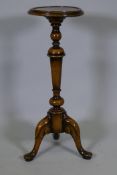 A Georgian style walnut candle stand, raised on turned tapering column and cabriole supports