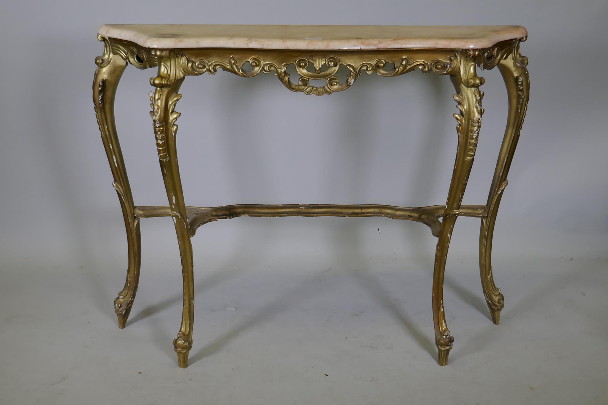An Italian giltwood console table with marble top and carved and pierced frieze, raised on shaped