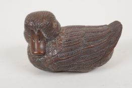 A Japanese carved wood okimono of a duck with stone set eyes, signed, 3" long