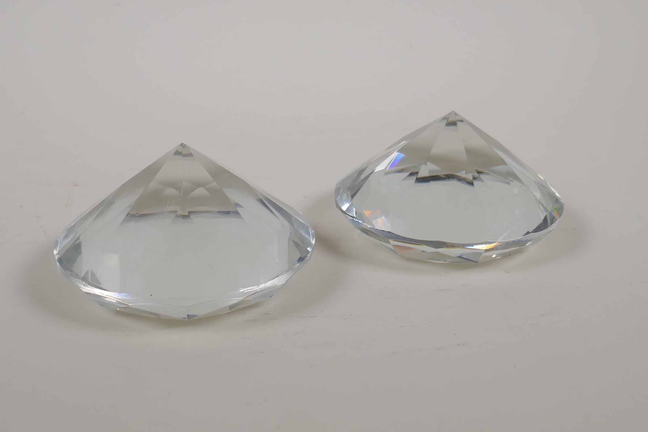 A pair of diamond shaped glass paperweights, 4" diameter