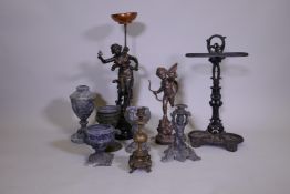 A quantity of metalware, metal lamps, urns and candle sticks and stick stand, 23" high