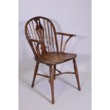 A C18/19th Windsor hoop back yew wood elbow chair, with pierced splat back, shaped and scrolled arms