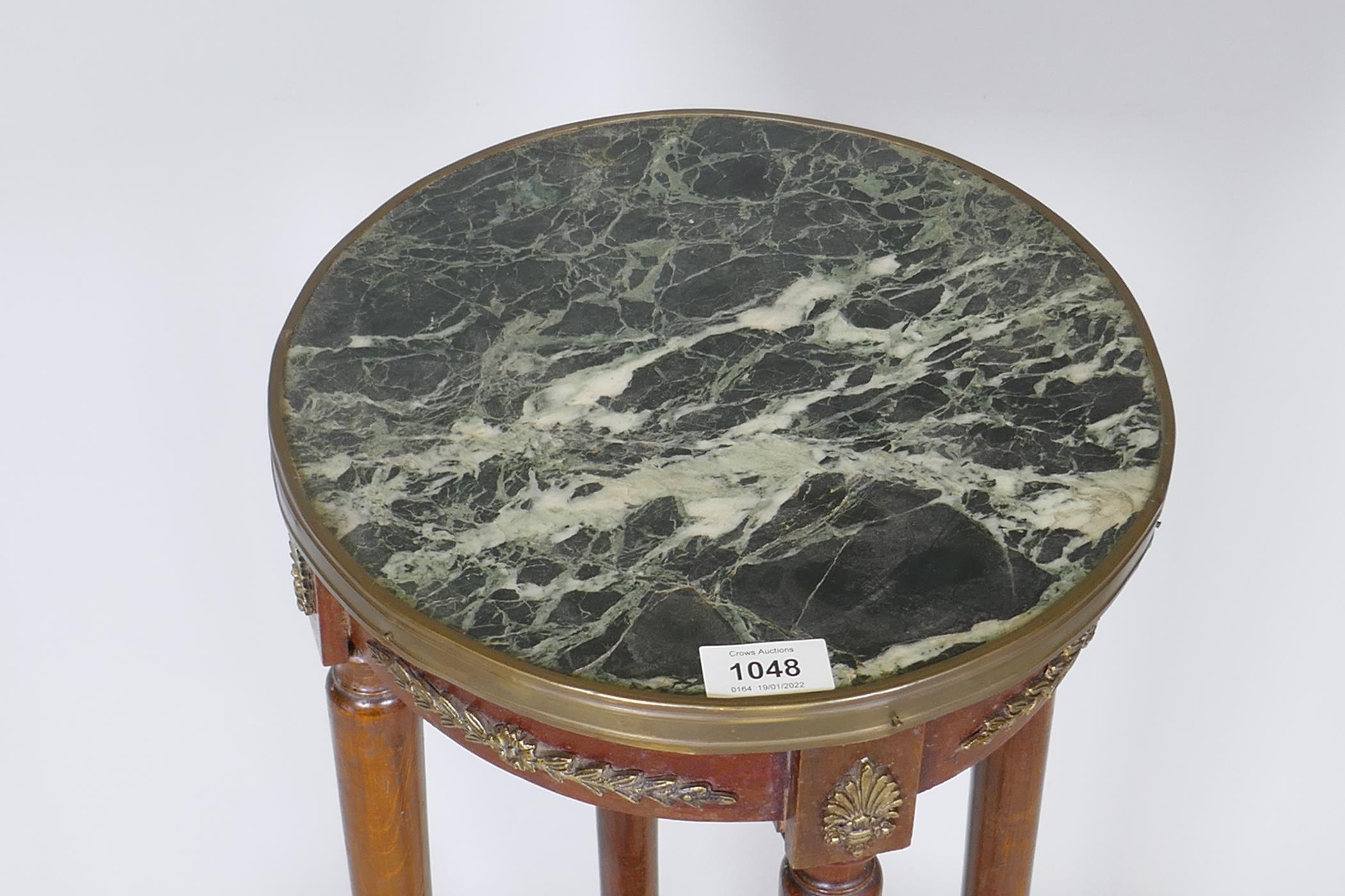 A French Empire style gueridon, with brass mounts and inset vert de mer marble top, raised on turned - Image 2 of 3