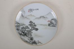 A Chinese monochrome porcelain cabinet plate decorated with a riverside landscape, character