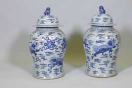 A pair of Chinese blue and white jars and covers with kylin decoration, 19" high