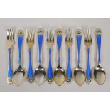 A set of silver gilt and enamel cake forks and tea spoons, the handles decorated with borromean