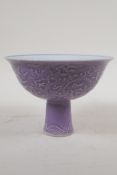 A Chinese mauve glazed porcelain stem bowl with underglaze dragon decoration, 6 character mark to
