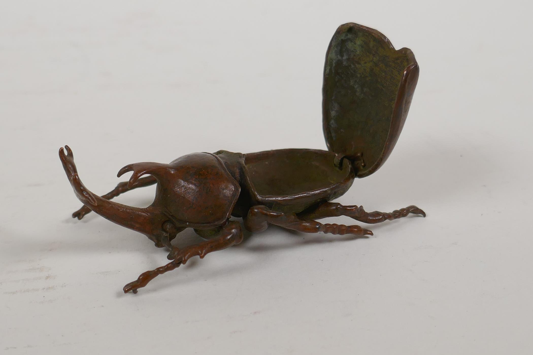 A Japanese Jizai style okimono in the form of a rhinoceros beetle, the carapace opening to reveal an - Image 4 of 5