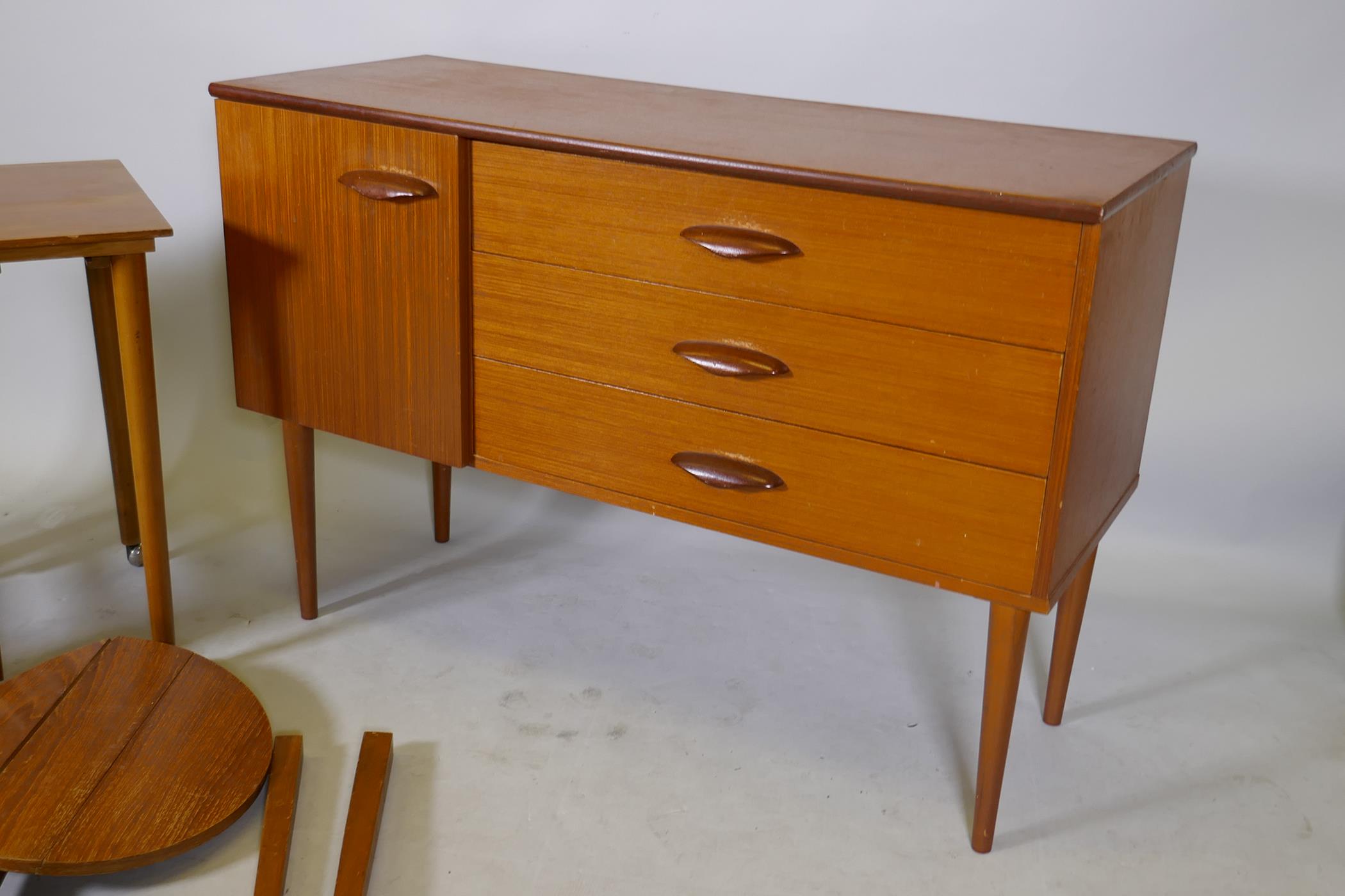 A 1970s teak side cabinet with three drawers and cupboard, and a nest of circular topped - Image 2 of 4