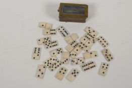 A miniature brass box containing twenty six bone dominoes, dominoes ¾" long