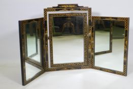 A 1920s black lacquer triptych dressing mirror with chinoiserie decoration, 24" high, 45" wide