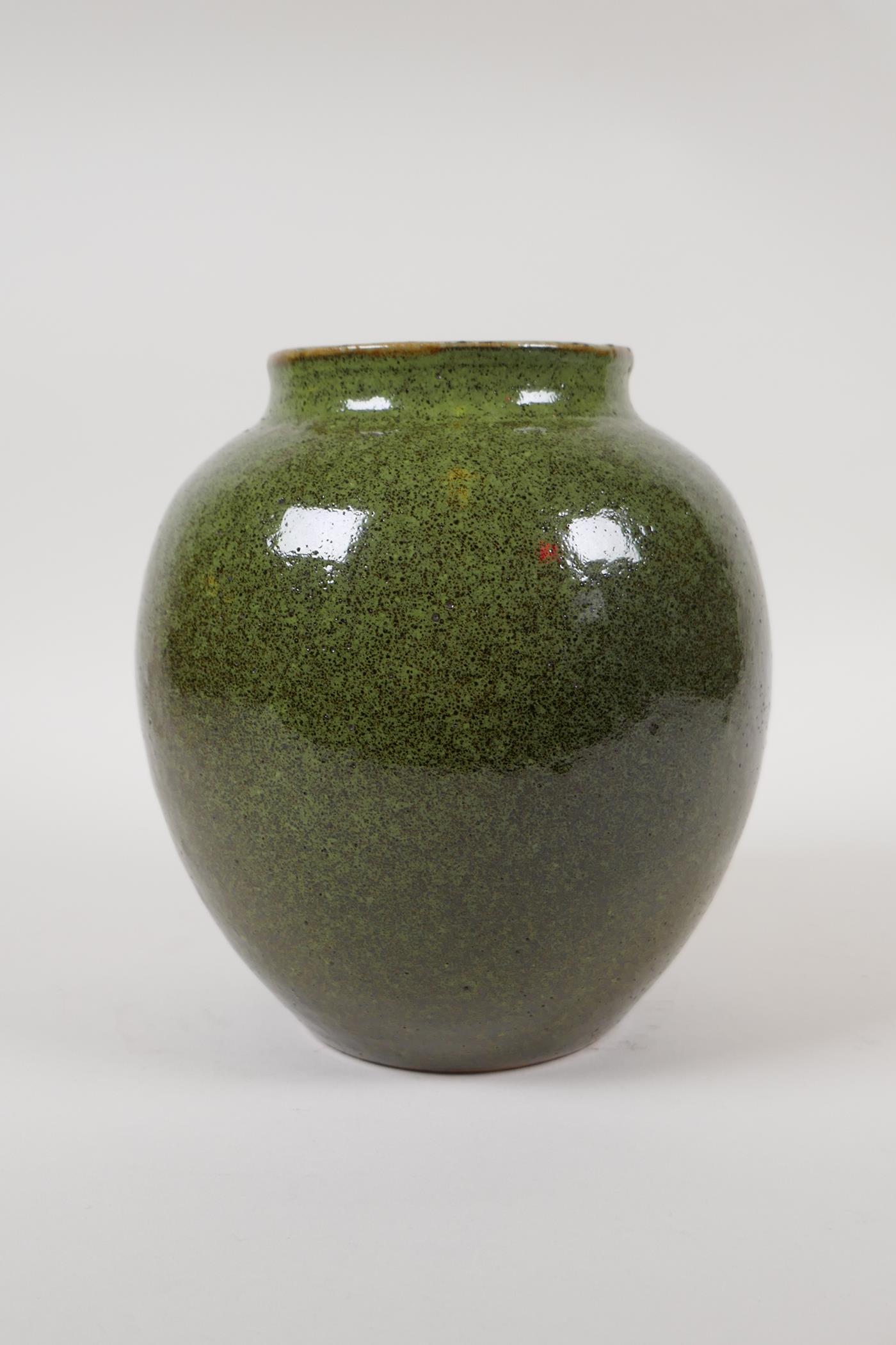 A Chinese green speckled glaze pottery jar, 7" high